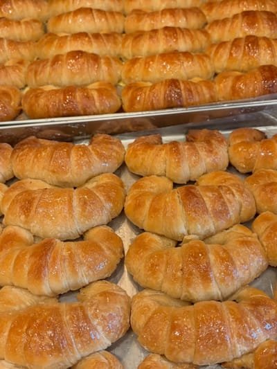 A tray of plain medialunas de manteca, glazed while still warm, in Richmond, VA
