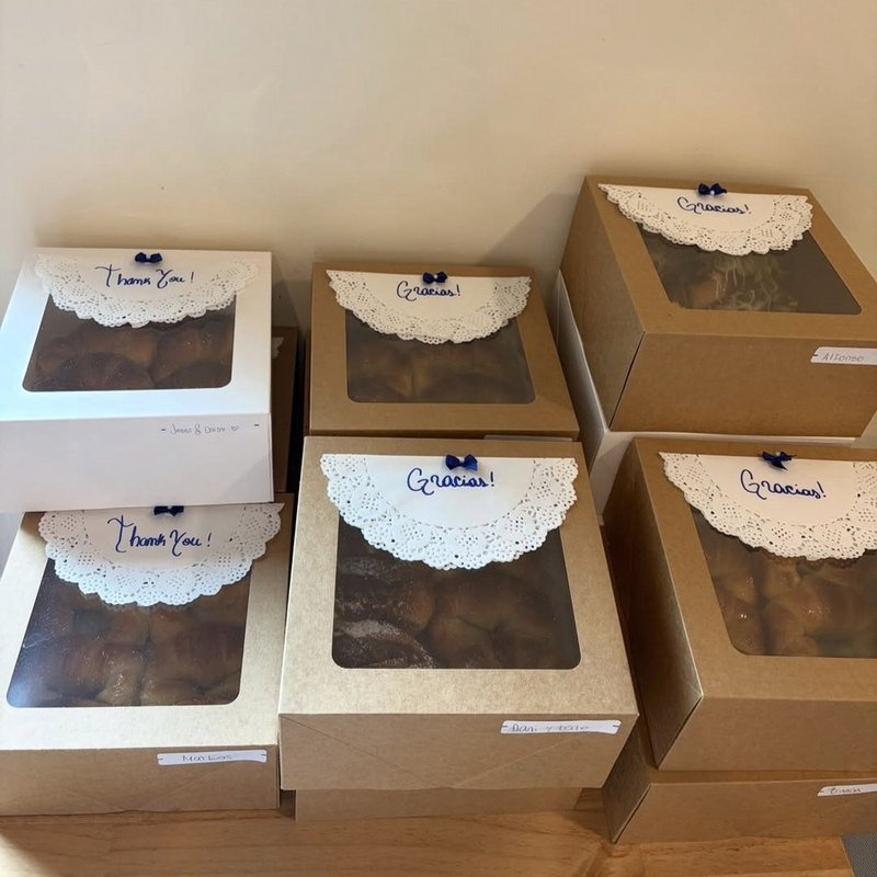 Kraft pastry boxes lined with paper doilies, tied with navy ribbon and written on by hand, boxed for collection in Richmond, VA