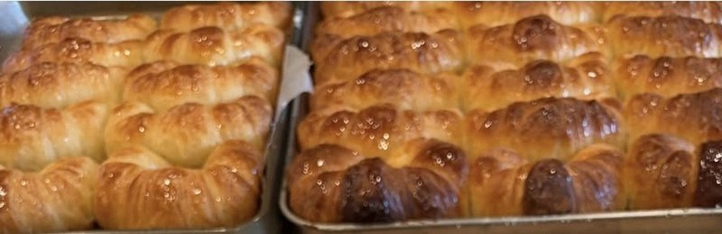 Trays of plain medialunas de manteca, glazed while still warm from the oven in Richmond, VA